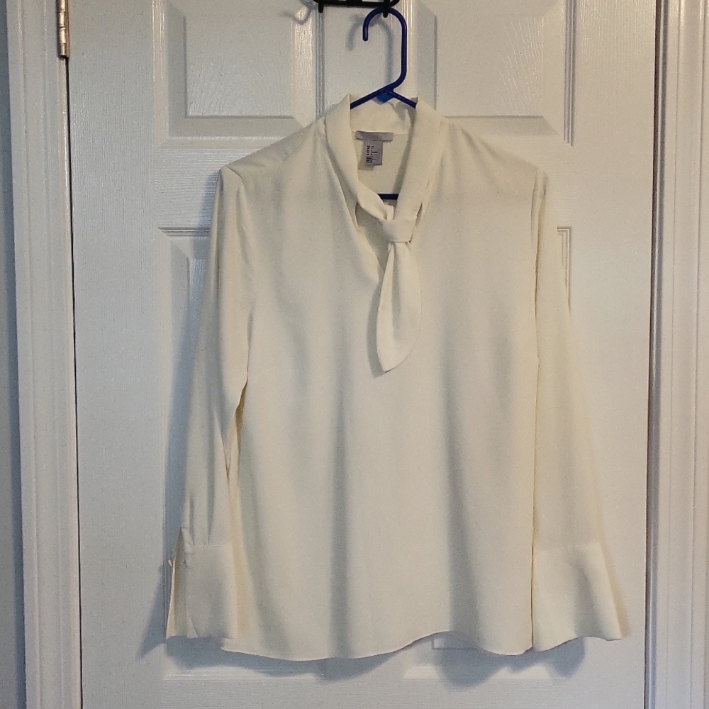 Womens dress shirt with tie neck and bell cuffs.